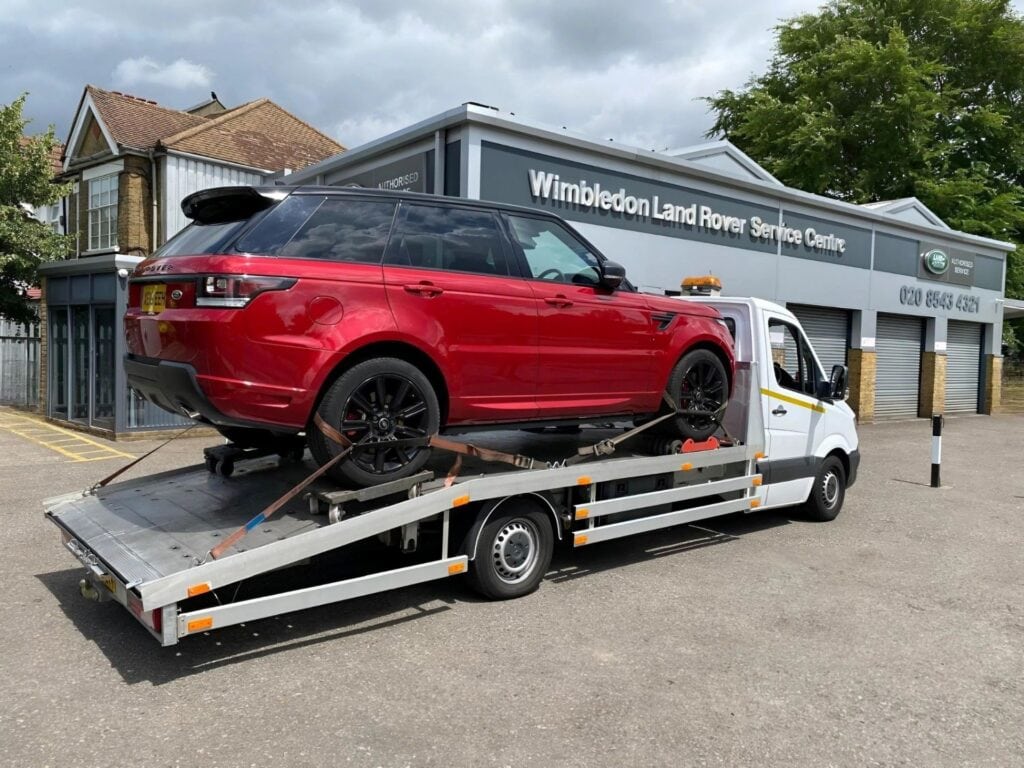 Range Rover Sport on a flatbed recovery truck during car recovery Wimbledon in SW20. Professional towing service Wimbledon.