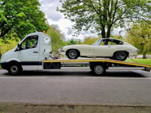Classic Jaguar E-Type on a flatbed recovery truck for professional high value car recovery Wimbledon experts.