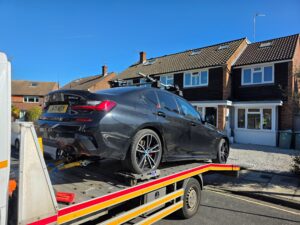 Professional BMW 330e electric car recovery Wimbledon on a reliable flatbed tow truck for a local hybrid vehicle owner.