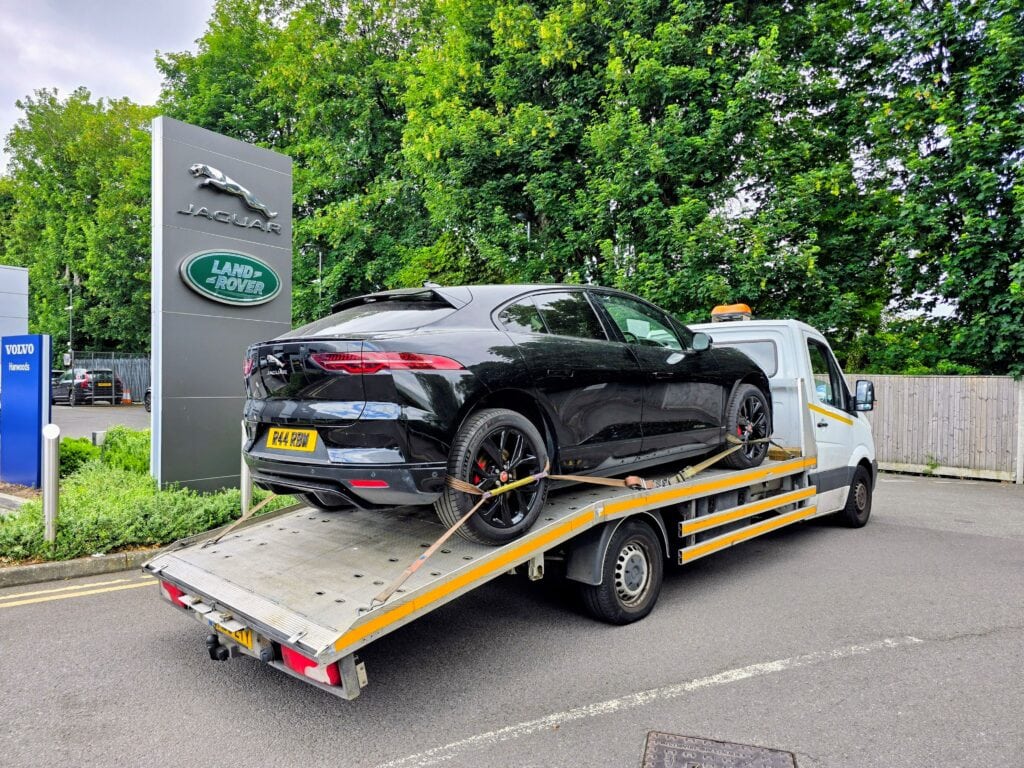 Professional electric car recovery Fulham for a Jaguar I-PACE being transported on a flatbed recovery truck in SW6.