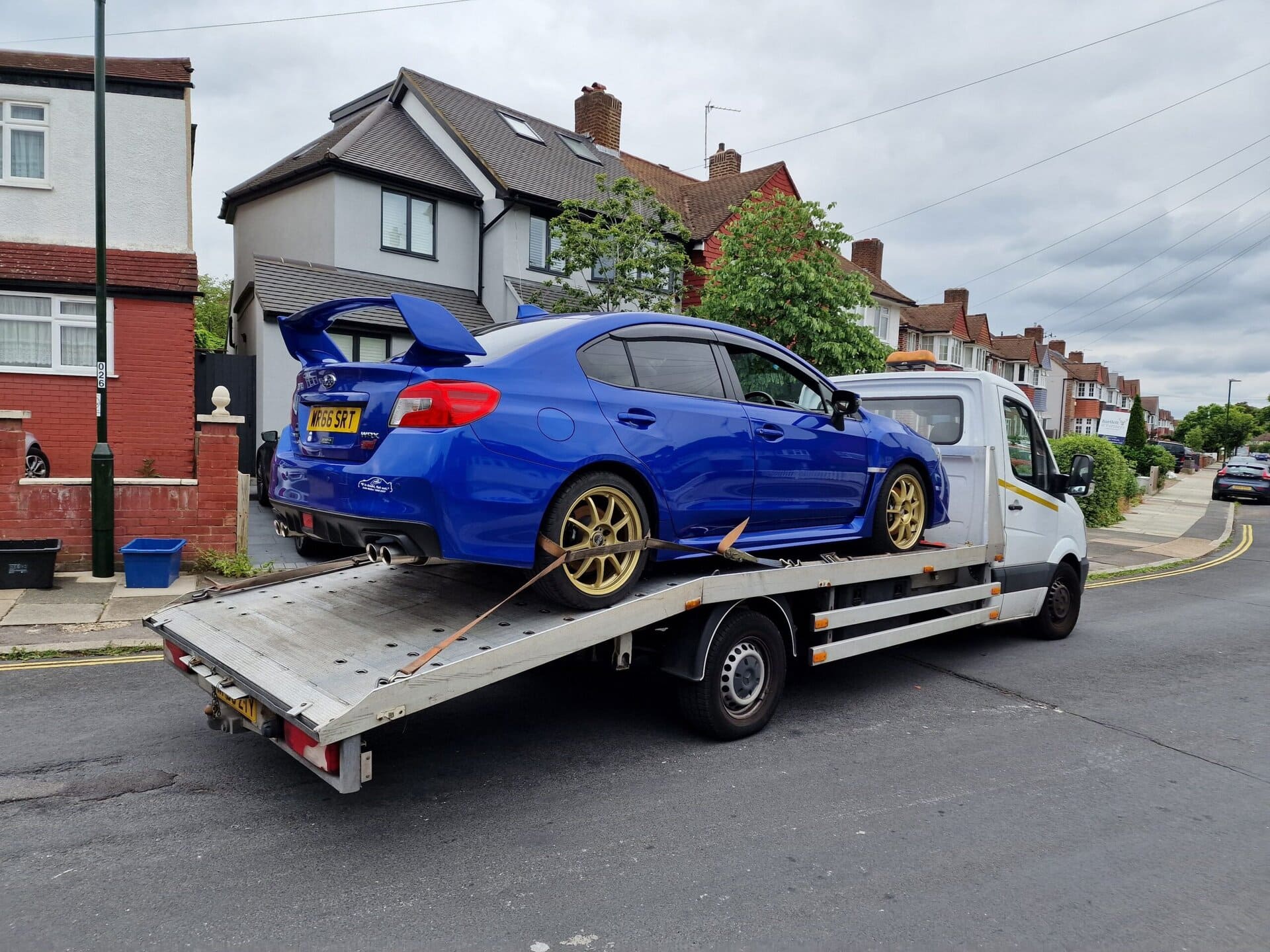 Blue Subaru WRX STI on a flatbed recovery truck. Over 20 years of experienced car recovery Wimbledon and towing since 2006.