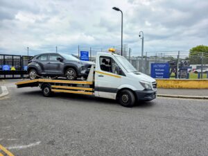 Grey Toyota Yaris Cross on a recovery truck at the Perivale police compound for a professional Fulham car recovery service.