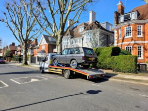 Range Rover Classic on a flatbed truck for professional roadside assistance Wimbledon service after a wrong fuel incident.