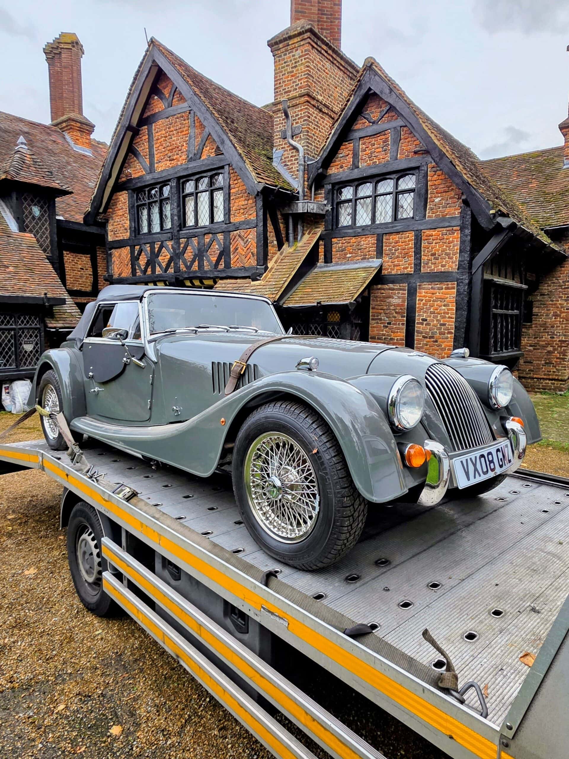 Classic grey Morgan Roadster on a flatbed tow truck during prestige car recovery in local Southwest London.