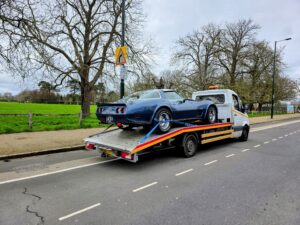 Classic blue Corvette C3 on a flatbed tow truck for professional emergency towing service Wimbledon.
