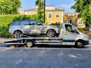 We buy any car Kensington vehicle collection using flatbed tow truck transporting Range Rover Sport