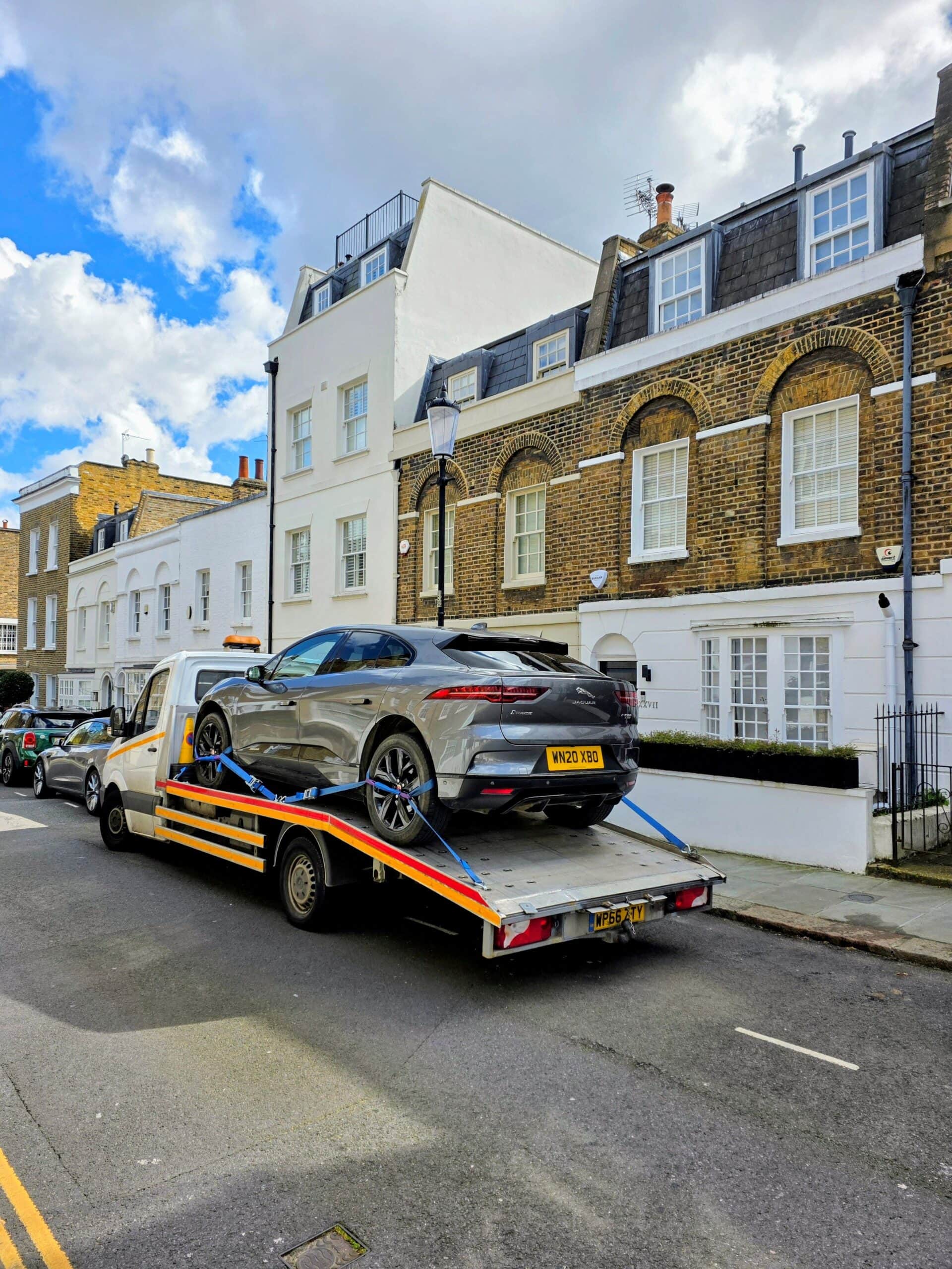 Jaguar I-Pace electric SUV on flatbed recovery truck — electric car recovery and towing service Chiswick W4