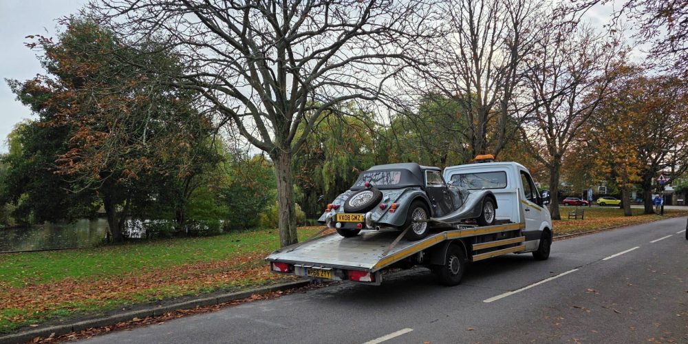 breakdown recovery London – classic car secured on a flatbed tow truck with low-angle ramp and soft straps