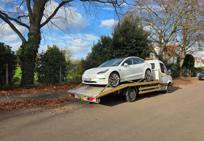 Tesla Model 3 on flatbed recovery truck – London Auto Towing car recovery and towing service